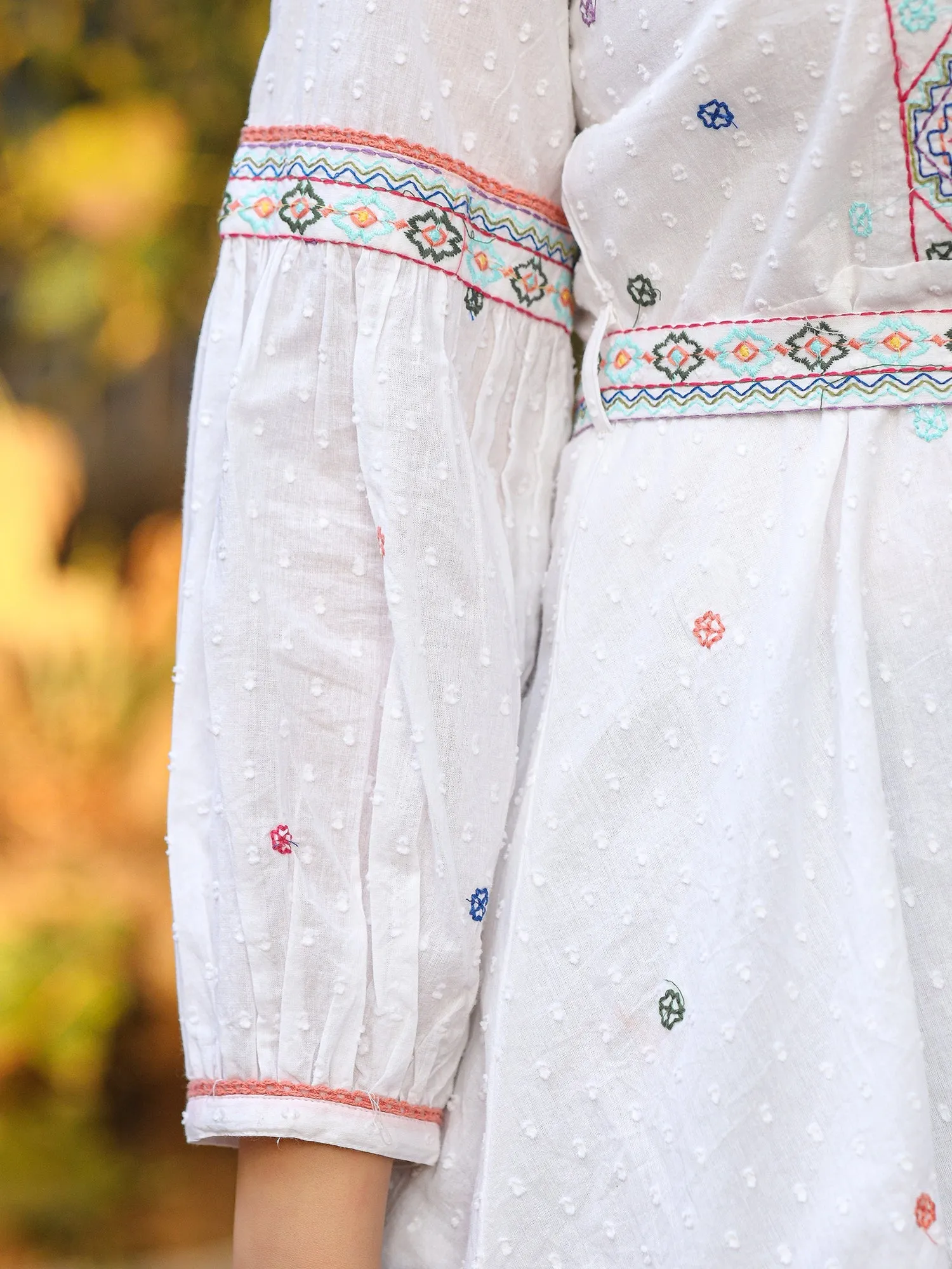 Jashvi White Cotton Dobby Peplum Tunic With Multi Colored Thread Embroidery